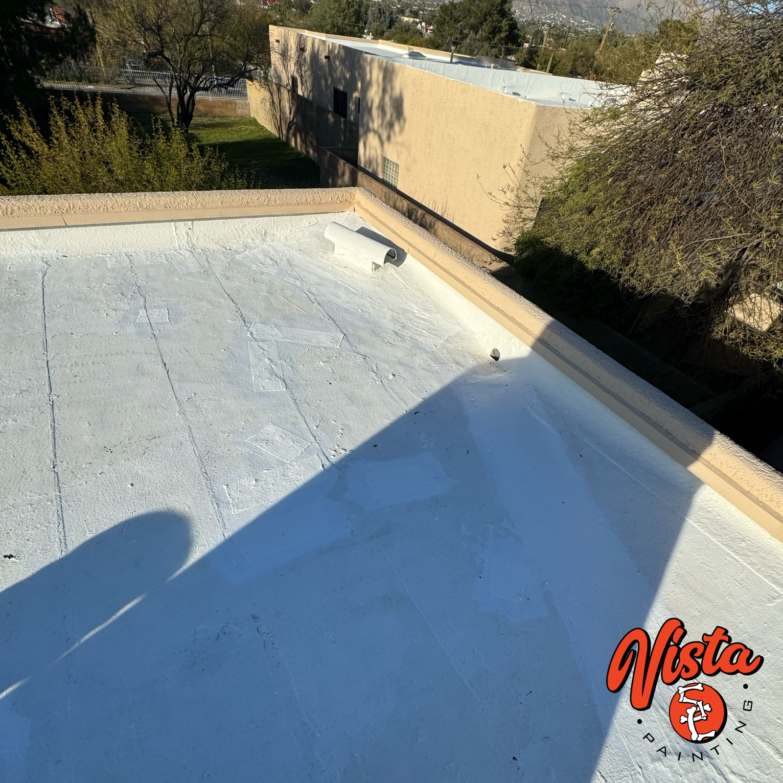 professional roof coating application on a residential flat roof in Tucson.