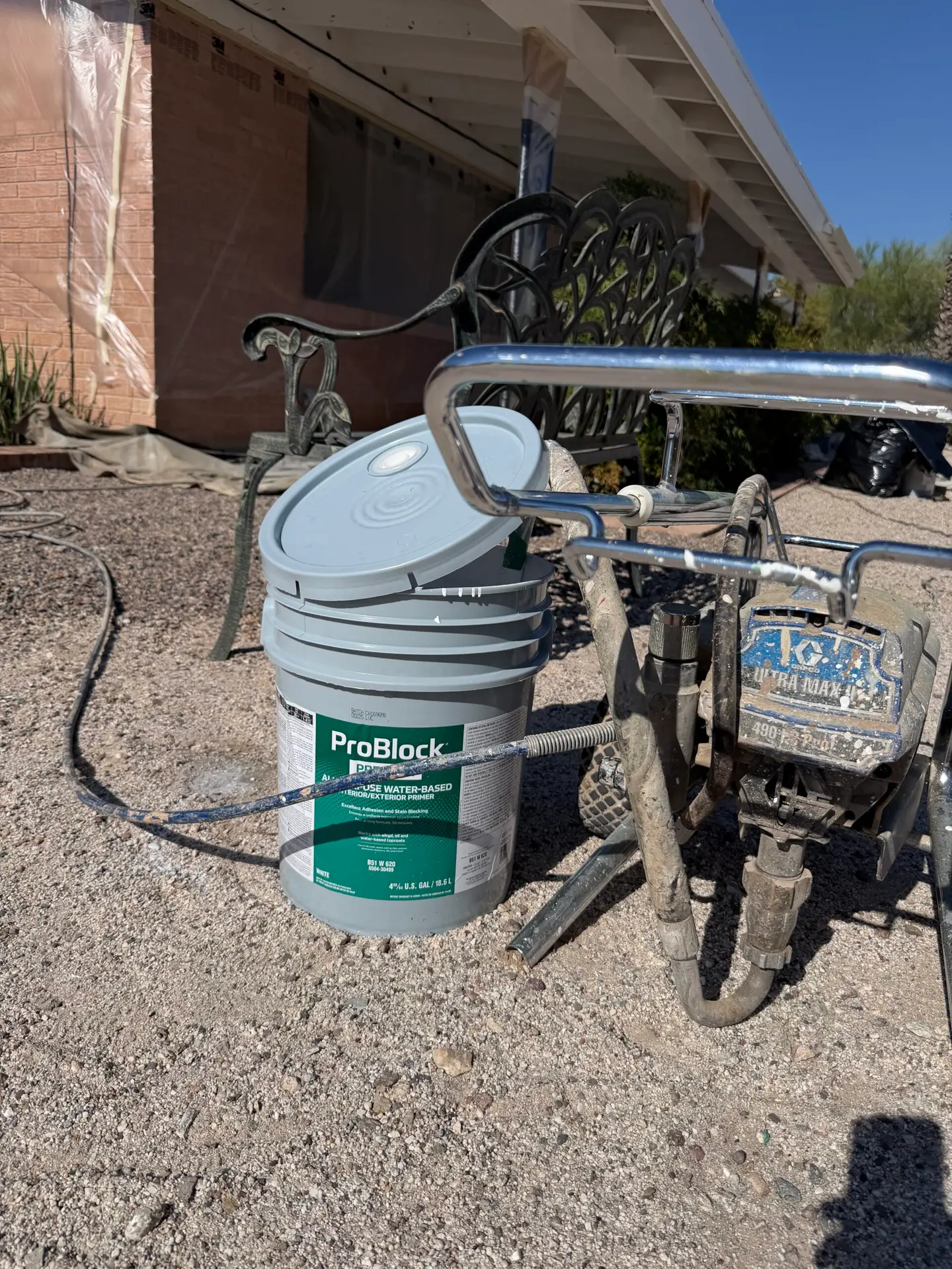 Sherwin-Williams ProBlock exterior primer and Graco Ultra Max II sprayer used for professional house painting in Tucson, Arizona.